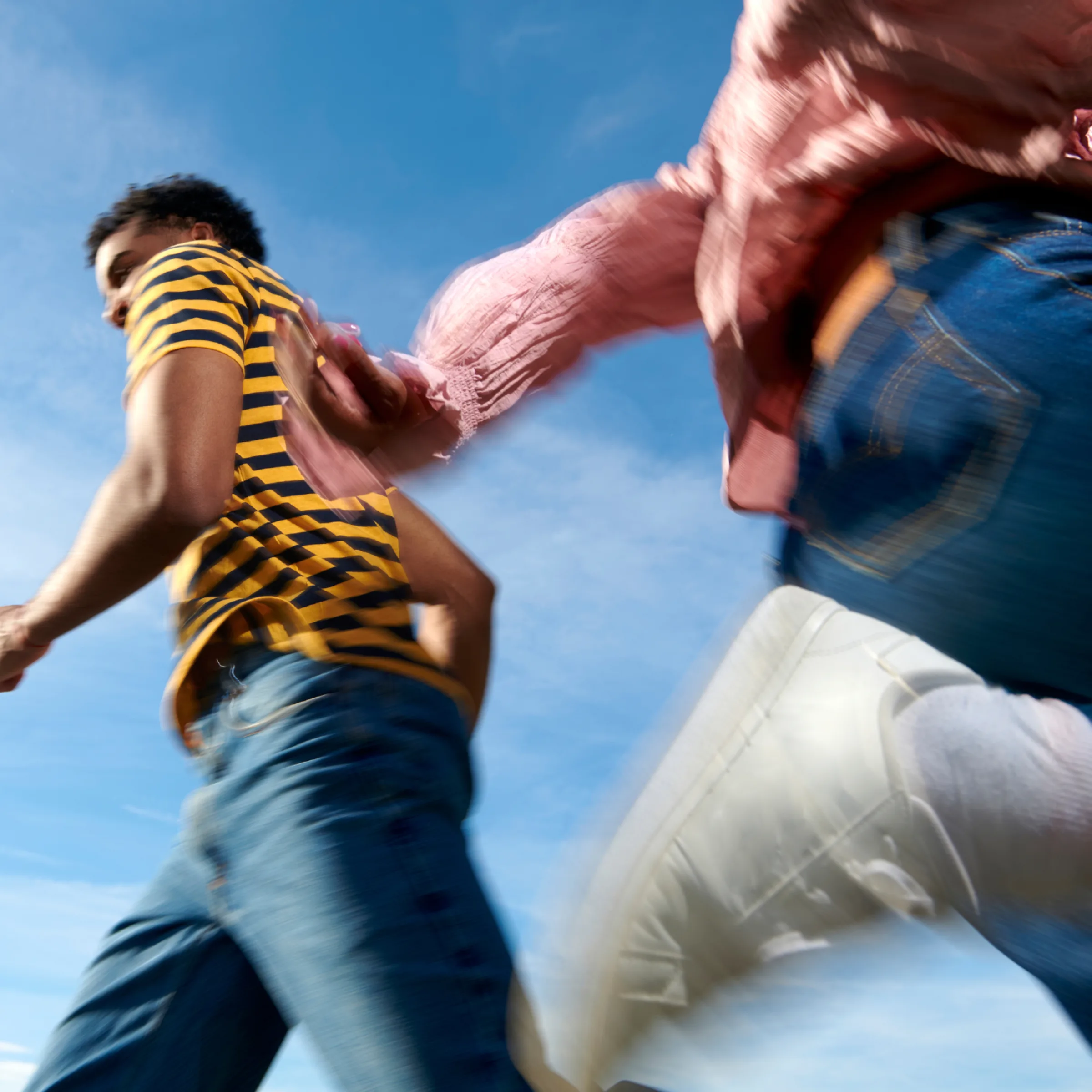 Kids running outdoors under a clear sky
